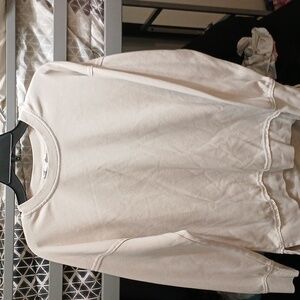 A tan sweat shirt, brand is pink rose, sise M